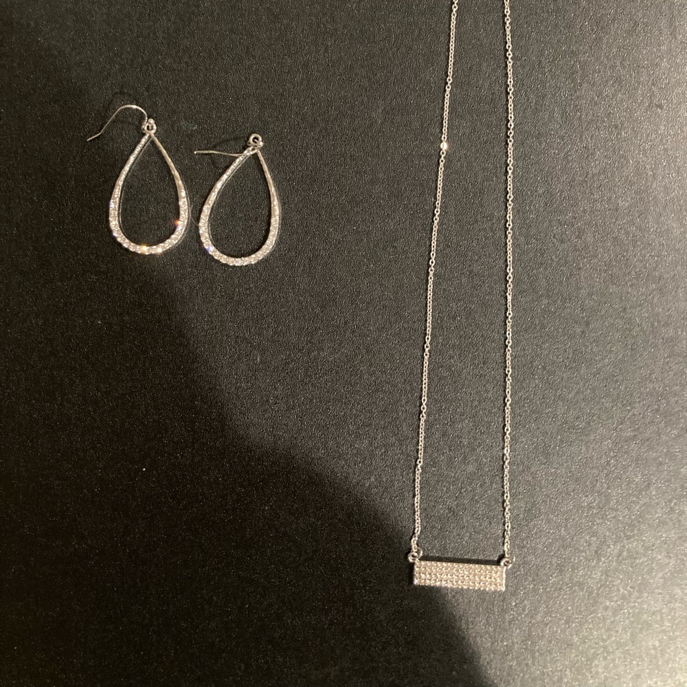 A pair of diamond earrings and matching necklace